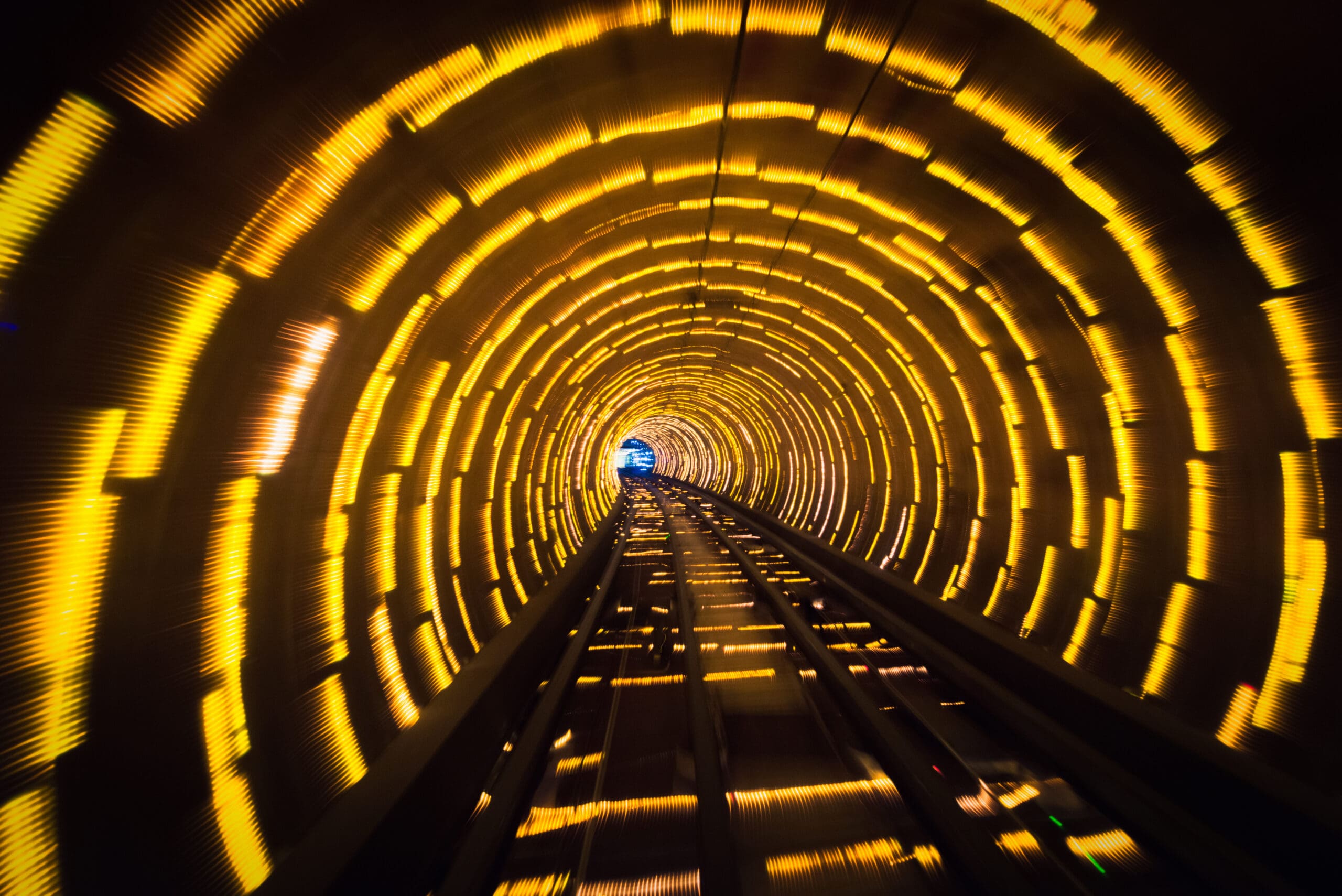 Motion blur on lines of LEDs illuminating a curving rail tunnel in Shanghai, China.